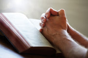 Praying hands over Bible - Crosscountrycreations